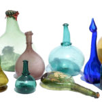A selection of Late Persian Glass, including saddle flasks, karabas, rose water bottles and other forms.